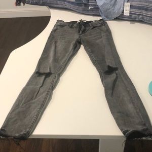 grey packing slightly ripped jeans! good as new
